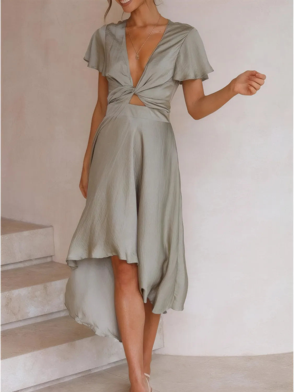 Close-up of fabric and flutter sleeve details of High-Low Plunge Flutter Sleeve Dress