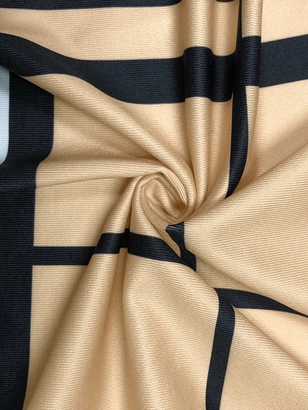Plus Size Plaid V-Neck Long Sleeve Wrap Dress fabric in beige with black plaid pattern.
