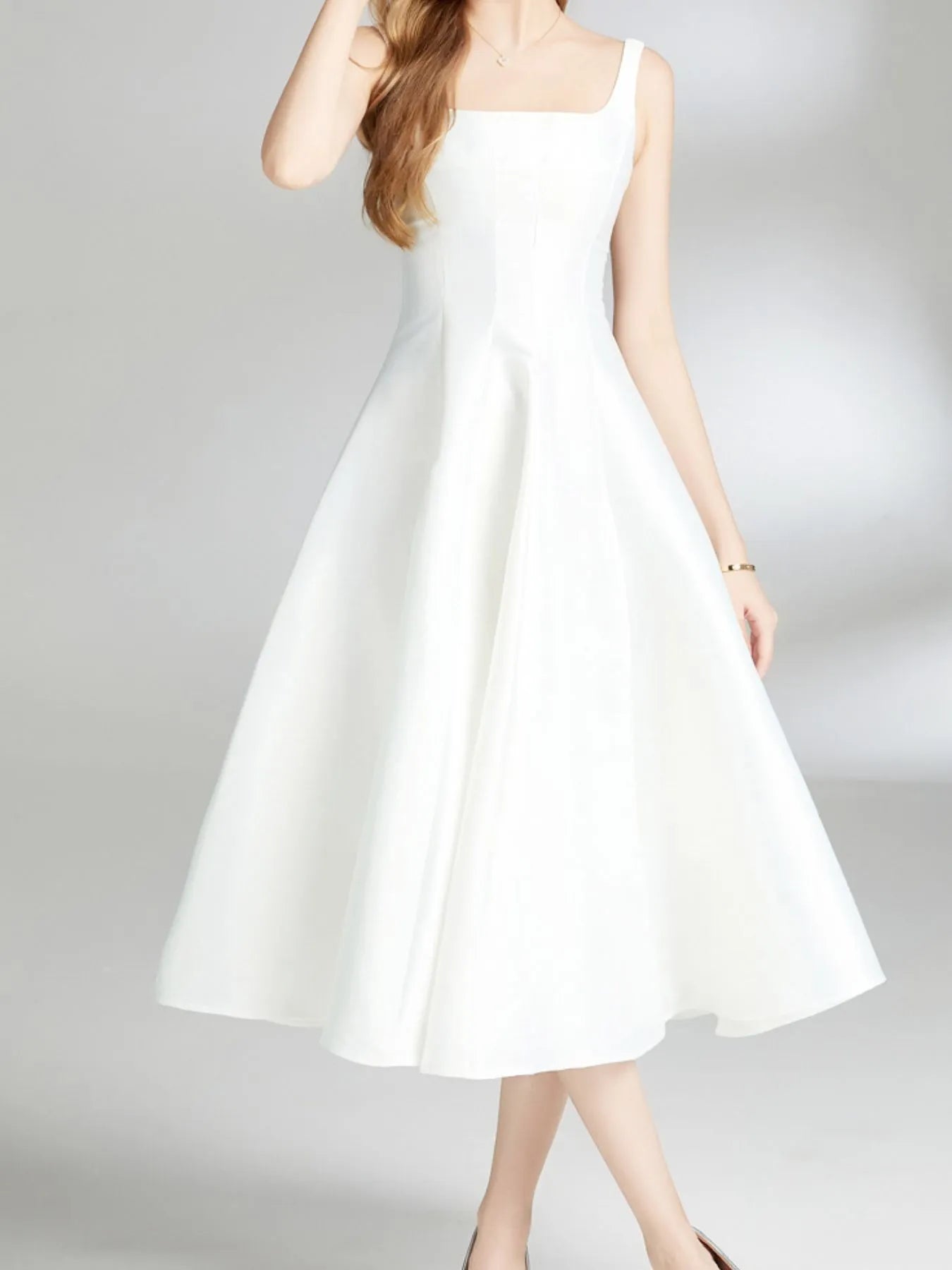 Elegant woman in a flowy Polyester Evening Dress, showcasing a chic square neckline and flared skirt.