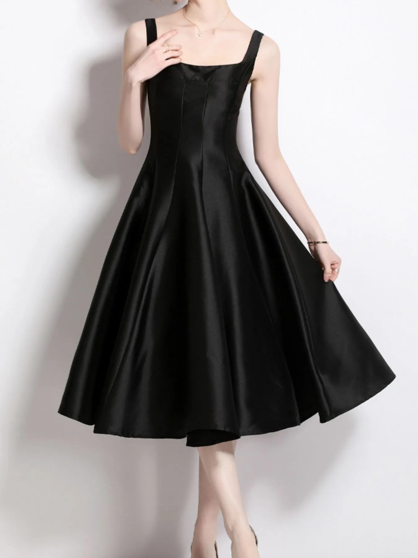 Elegantly designed Polyester Evening Dress for Women in classic black, showcasing a flared skirt and spaghetti straps.