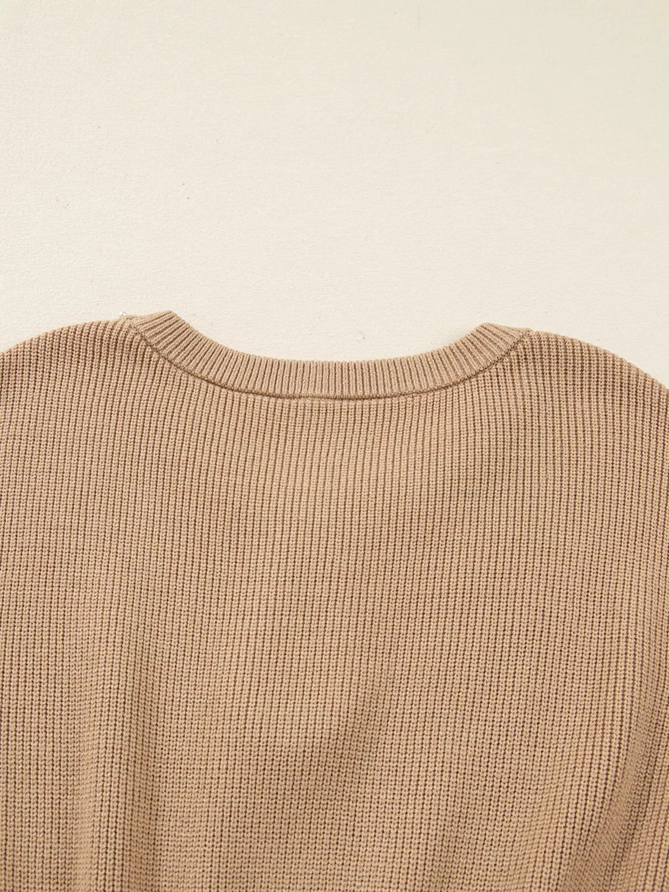Back view of a stylish knit sweater dress for women, showcasing the fine ribbed texture and elegant neckline.
