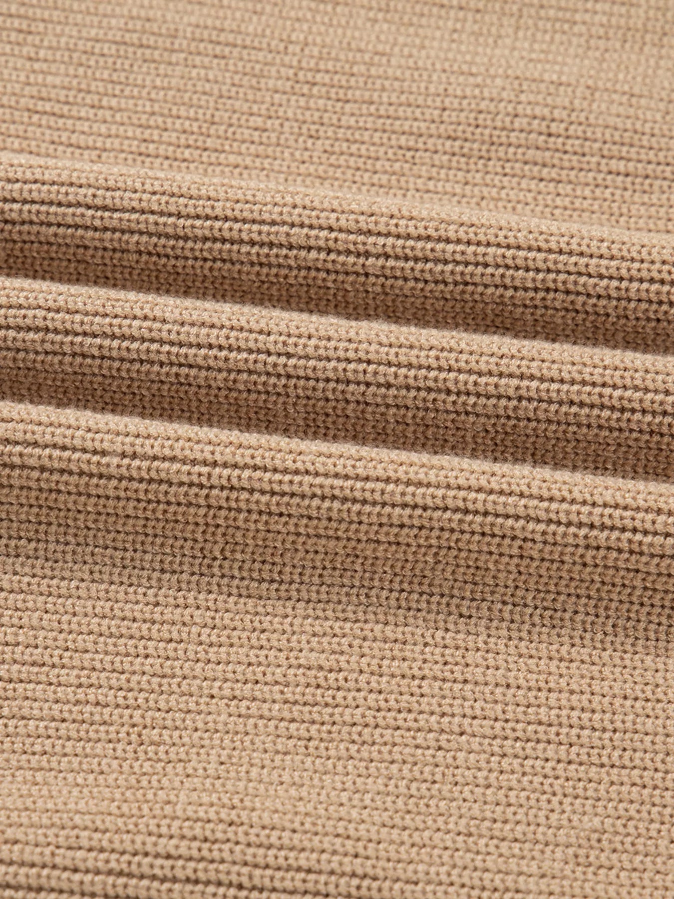 Close-up of the soft knit fabric used for a stylish knit sweater dress for women, showcasing texture and warmth.